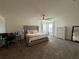 Large main bedroom featuring a tufted headboard bed, a ceiling fan, with bright natural light, and a work space at 2346 Upland Ln, Apopka, FL 32712
