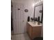 Cozy bathroom featuring a vanity with a sink, a mirror, and a decorative 'Be Our Guest' sign on the door at 2377 Paulette Dr, Haines City, FL 33844