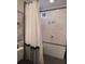 Cozy bathroom featuring tiled shower with shower curtain and 'relax' wall art at 2377 Paulette Dr, Haines City, FL 33844