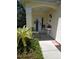 Charming front porch with a welcome banner, seating, and decorative nautical elements for a warm greeting at 2377 Paulette Dr, Haines City, FL 33844