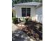 Inviting front yard featuring a bench with flower pots and a quaint garden gnome for added charm at 2377 Paulette Dr, Haines City, FL 33844