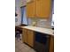 Functional kitchen area with a desk, wooden cabinets, stylish backsplash, and modern appliances at 2377 Paulette Dr, Haines City, FL 33844