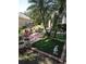 Well-maintained landscaping features decorative plants and brick-lined areas, enhancing the yard's aesthetic appeal at 2377 Paulette Dr, Haines City, FL 33844