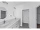 Modern bathroom with double vanity, gray cabinets, and a large mirror at 16941 Sw 30Th Avenue Sw Rd, Ocala, FL 34473