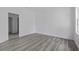 Simple bedroom with gray vinyl plank flooring and access to a bathroom at 16941 Sw 30Th Avenue Sw Rd, Ocala, FL 34473