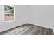 Spacious bedroom with gray vinyl plank flooring and a large window at 16941 Sw 30Th Avenue Sw Rd, Ocala, FL 34473