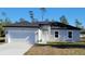Newly constructed one-story home with gray exterior and a two-car garage at 16941 Sw 30Th Avenue Sw Rd, Ocala, FL 34473