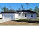 Newly built one-story house, gray exterior, two-car garage, and well-manicured lawn at 16941 Sw 30Th Avenue Sw Rd, Ocala, FL 34473