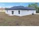 White house exterior with a dark gray roof and sliding glass doors at 16941 Sw 30Th Avenue Sw Rd, Ocala, FL 34473