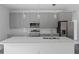 Modern kitchen featuring gray cabinets, quartz countertops, and stainless steel appliances at 16941 Sw 30Th Avenue Sw Rd, Ocala, FL 34473