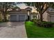 Two-story house with a two-car garage and landscaped lawn at 2616 Bowring St, Kissimmee, FL 34747