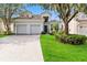 Two-story house with a two-car garage and well-manicured lawn at 2616 Bowring St, Kissimmee, FL 34747