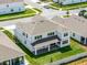 Aerial view of the backyard showcasing a covered patio, lush green lawn, and neighborhood surroundings at 3198 Sailing Pier Ave, Winter Garden, FL 34787