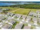 Aerial view of a neighborhood with well-maintained lawns, houses, and streets under a cloudy sky at 3198 Sailing Pier Ave, Winter Garden, FL 34787
