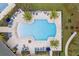 Top-down view of community pool surrounded by palm trees, lounge chairs, and shaded seating areas at 3198 Sailing Pier Ave, Winter Garden, FL 34787