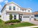 Two-story home with a three-car garage, brick paver driveway, and manicured lawn at 3198 Sailing Pier Ave, Winter Garden, FL 34787