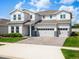 Two-story home with a three-car garage, brick paver driveway, manicured lawn and white siding at 3198 Sailing Pier Ave, Winter Garden, FL 34787