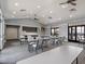 Spacious meeting room with tables, chairs, kitchenette, and access to outdoor amenities at 3198 Sailing Pier Ave, Winter Garden, FL 34787