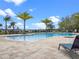 Community swimming pool surrounded by lounge chairs and manicured landscaping at 3198 Sailing Pier Ave, Winter Garden, FL 34787