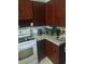 Cozy kitchen featuring wood cabinets and modern appliances at 108 5Th Jpv St, Winter Haven, FL 33880