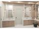 Elegant bathroom featuring double vanity, marble countertops and a neutral palette with modern fixtures and finishes at 110 W Railway Ave, Oakland, FL 34760