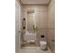 Compact bathroom featuring wood paneled walls, sleek fixtures, and a floating vanity for a clean, modern look at 110 W Railway Ave, Oakland, FL 34760