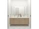Elegant bathroom with double vanity, light wood cabinets and marble countertops with decorative vase accent at 110 W Railway Ave, Oakland, FL 34760