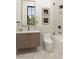 Bathroom featuring a modern floating vanity, toilet, and shower-tub with black hardware, offering sleek style at 110 W Railway Ave, Oakland, FL 34760
