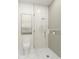 Modern bathroom features a gold-framed glass shower, toilet, and decorative wall art accenting the space at 110 W Railway Ave, Oakland, FL 34760