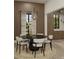 Elegant dining area featuring stylish lighting, wood paneling, and seating for four at 110 W Railway Ave, Oakland, FL 34760
