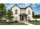 Charming two-story home with stone accents, landscaped yard, and welcoming front porch at 110 W Railway Ave, Oakland, FL 34760