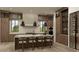 Modern kitchen with stainless steel appliances, large marble island, and stylish pendant lighting at 110 W Railway Ave, Oakland, FL 34760