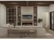 Cozy living room with a fireplace, built-in shelving, and comfortable seating area at 110 W Railway Ave, Oakland, FL 34760