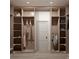 Spacious walk-in closet with custom wood shelving, rods for hanging clothes and ample storage space at 110 W Railway Ave, Oakland, FL 34760