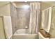 Clean bathroom featuring shower-tub combination with gray tile and neutral color scheme at 1687 Kona Ln, Davenport, FL 33897
