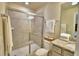 Elegant bathroom with a tiled shower featuring sliding glass doors and neutral color palette at 1687 Kona Ln, Davenport, FL 33897
