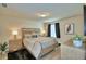 Inviting bedroom with modern decor, wood-look floors, and ambient lighting for a cozy atmosphere at 1687 Kona Ln, Davenport, FL 33897