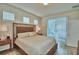 Bedroom featuring stylish furniture, natural light, and sliding door access to the backyard at 1687 Kona Ln, Davenport, FL 33897