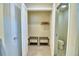 Organized walk-in closet with shelving, hanging space, and ensuite bathroom at 1687 Kona Ln, Davenport, FL 33897