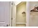 A well-lit walk-in closet with ample hanging space and custom wooden flooring at 1687 Kona Ln, Davenport, FL 33897