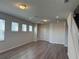 Spacious living area with modern flooring, neutral paint, and staircase access at 1687 Kona Ln, Davenport, FL 33897