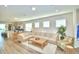 Cozy living room with neutral tones, comfortable seating, and an open flow to the kitchen and dining area at 1687 Kona Ln, Davenport, FL 33897
