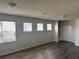 Bright living area with multiple windows, neutral paint, and modern flooring at 1687 Kona Ln, Davenport, FL 33897