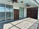 Spacious covered patio with tile flooring, ceiling fans, and access to the pool at 1687 Kona Ln, Davenport, FL 33897