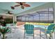 Inviting screened patio with ceiling fans and stylish furniture overlooking the sparkling pool at 1687 Kona Ln, Davenport, FL 33897