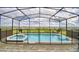 A screened-in pool and hot tub, overlooking a beautiful green space in a fenced in back yard at 1687 Kona Ln, Davenport, FL 33897