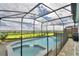 A screened-in pool and hot tub, overlooking a beautiful green space at 1687 Kona Ln, Davenport, FL 33897