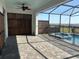 Covered patio with brick pavers overlooking a fenced pool and spa at 1687 Kona Ln, Davenport, FL 33897