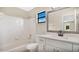 Updated bathroom with white vanity and tiled shower at 7972 Snowberry Cir, Orlando, FL 32819