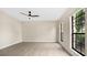 Spacious bedroom with large windows and ceiling fan at 7972 Snowberry Cir, Orlando, FL 32819